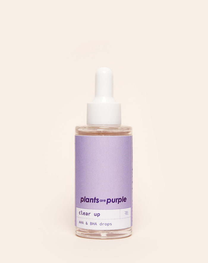 A bottle of 'plants are purple' AHA & BHA drops with a dropper cap.