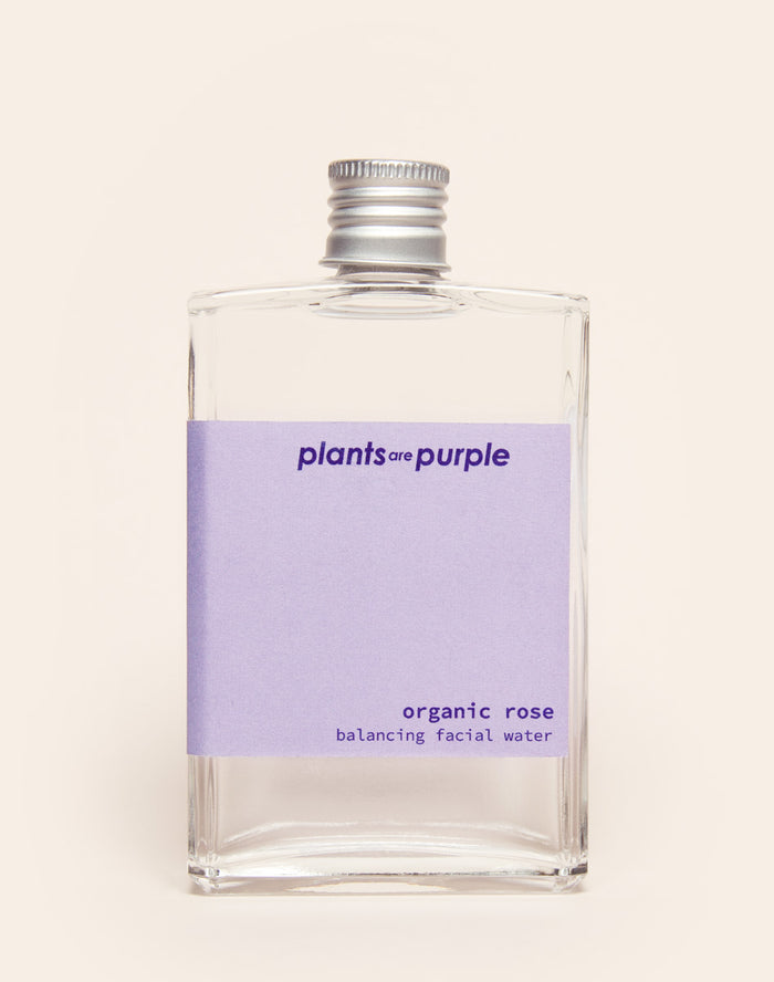 Clear bottle with a lavender label reading 'plants are purple, organic rose facial water.'
