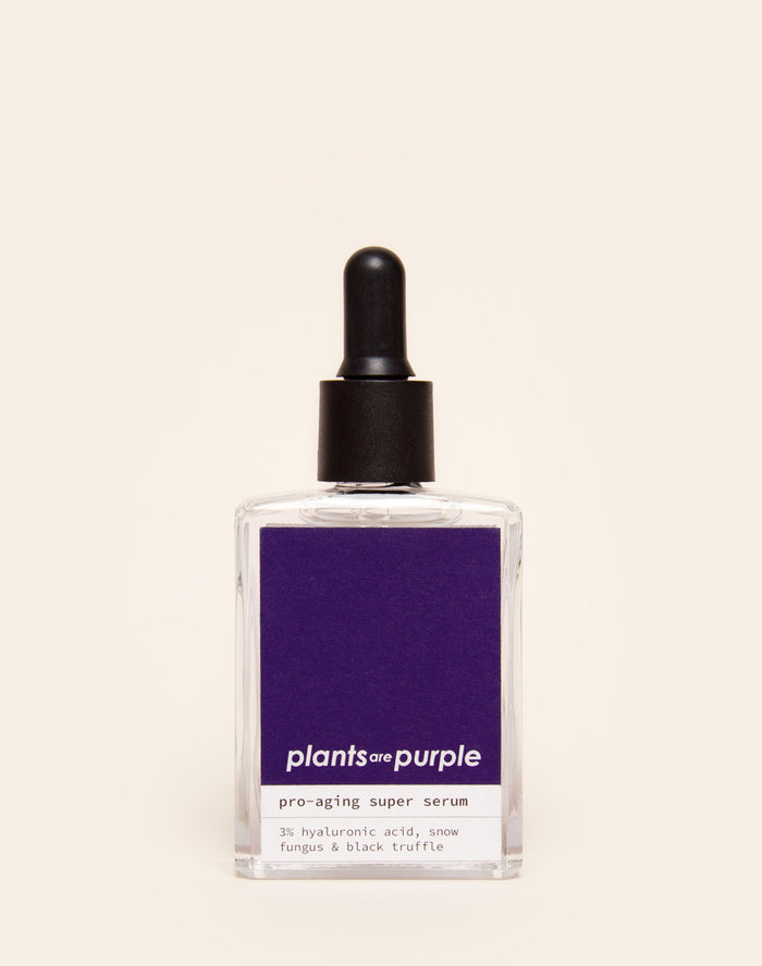 Pro-aging super serum bottle with dark dropper cap and purple label.