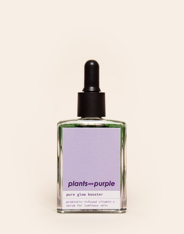 Glass bottle of 'plants are purple' vitamin C serum with dropper.