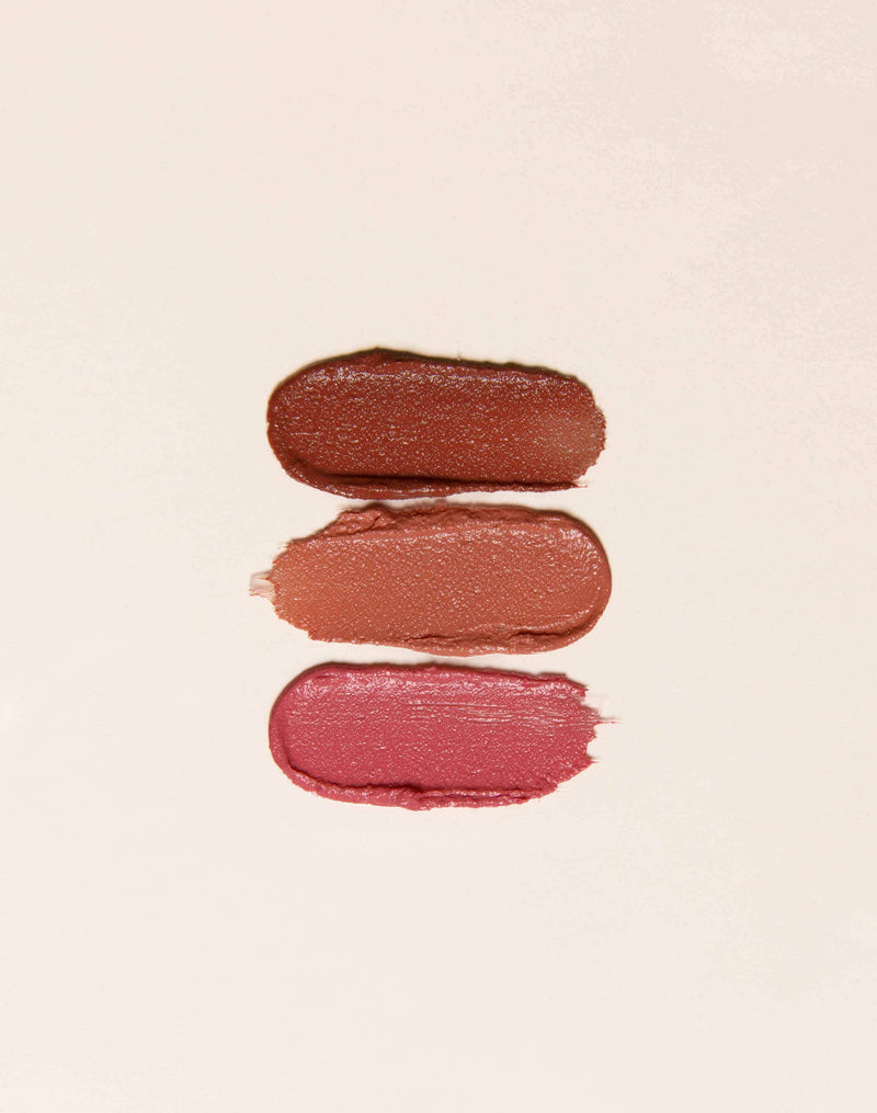 Three swatches of lipstick in varying shades against a light background.