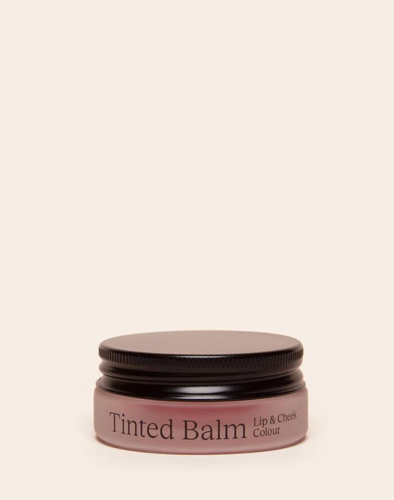 Container of tinted balm for lip and cheek color with a black lid.