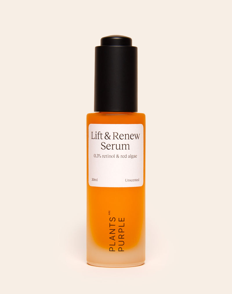 Orange serum bottle labeled 'Lift & Renew' with black cap on beige background.