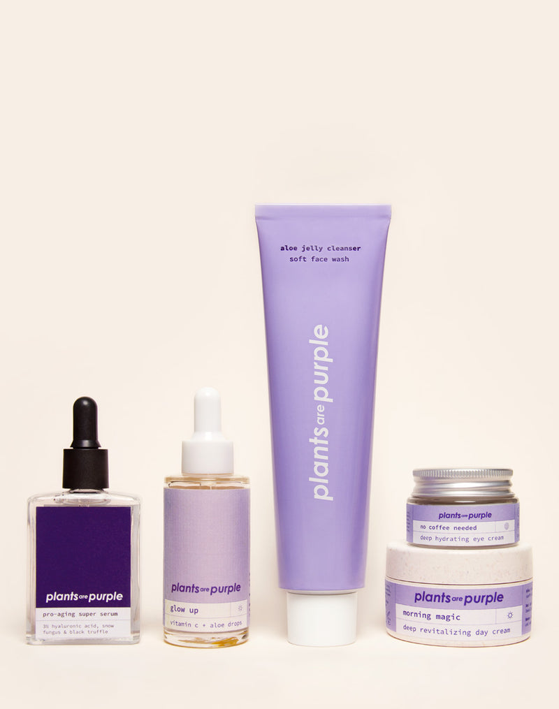 Skincare products with purple labels displayed on a light background.